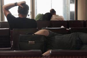 Passengers waiting in an airport departure lounge