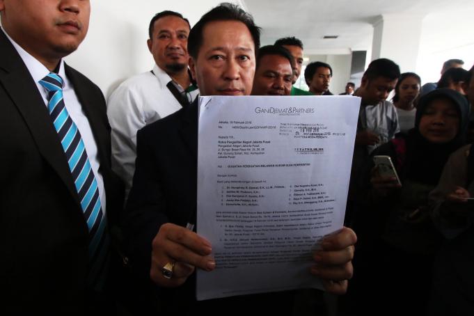Ketua Tim Kuasa Hukum PPP Humphrey R. Djemat (tengah) menujukkan sejumlah dokumen gugatan usai menghadiri sidang perdana kasus gugatan PPP terhadap presiden dan sejumlah menteri di Pengadilan Jakarta Pusat, Jakarta, Selasa (15/3).