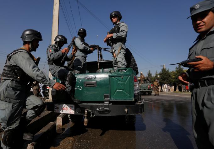 Afghan policemen arrive at the site of a suicide attack in Kabul