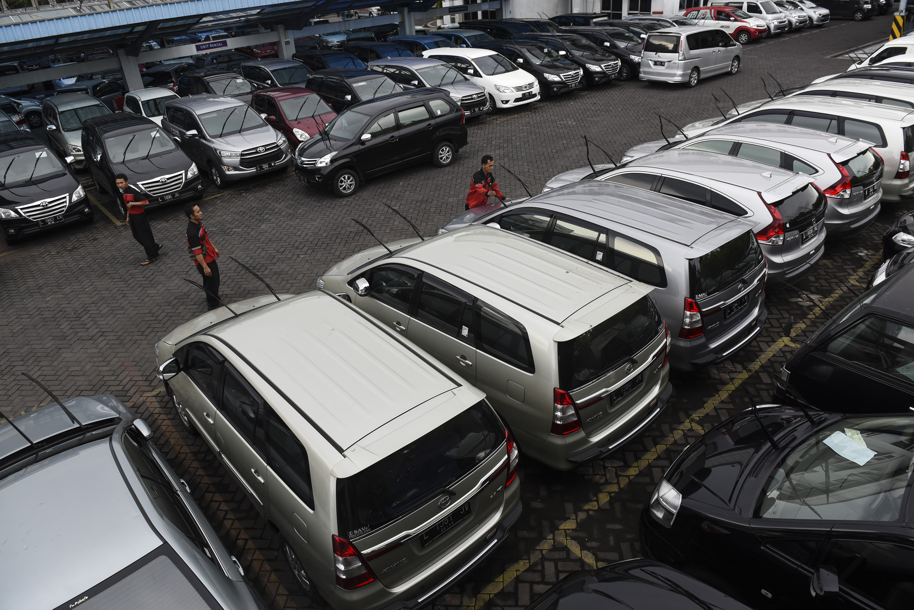 Pekerja memeriksa kondisi mobil di perusahaan penyewaan mobil Trac Astra di Surabaya, Jawa Timur, Kamis (30/6).