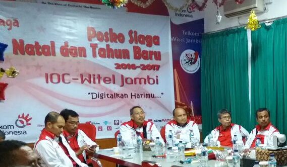 Direktur Network, IT & Solution Telkom Abdus Somad Arief (keempat dari kanan) saat melakukan pengecekan Posko TelkomGroup Siaga Natal & Tahun Baru secara nasional melalui teleconference dari Wilayah Telekomunikasi (Witel) Jambi (23/12). TelkomGroup mengoperasikan 83 Posko Utama di seluruh Indonesia yang memonitor dan mengawal kualitas layanan telekomunikasi selama 24 jam demi kenyamanan pelanggan selama libur natal dan tahun baru