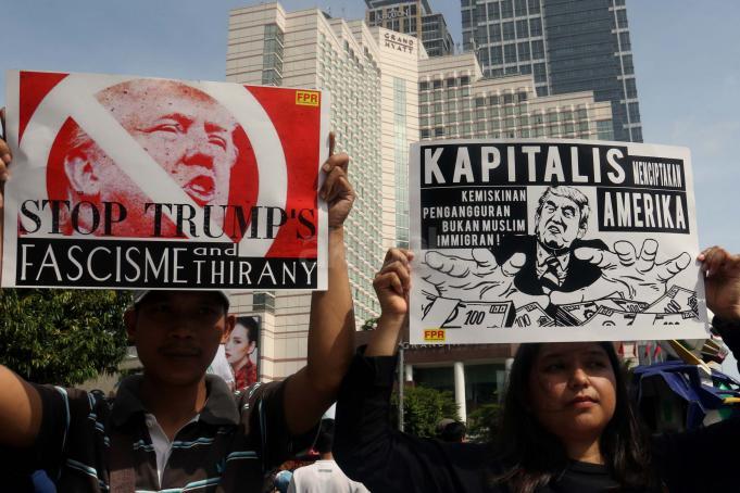 Sejumlah masa yang tergabung dalam front Perjuangan Rakyat membentangkan spanduk dan membawa poster saat melakukan aksi yang mengecam kebijakan Presiden Amerika Serikat Donald Trump di kawasan Bunderan HI, CFD, Jakarta, Minggu (5/2/2017). Dalam aksinya mereka mendesak agar Presiden Donald Trump mencabut kebijakan yang merugikan imigran muslim. AKTUAL/Munzir