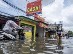 BPBD DKI Peringatkan Ancaman Banjir Rob di Pesisir Utara Jakarta hingga Awal Februari Warga melintasi banjir yang merendam perkampungan di Rawa Buaya, Cengkareng, Jakarta Barat, Sabtu (24/1/2026). (ANTARA FOTO/Bayu Pratama S/nz.)